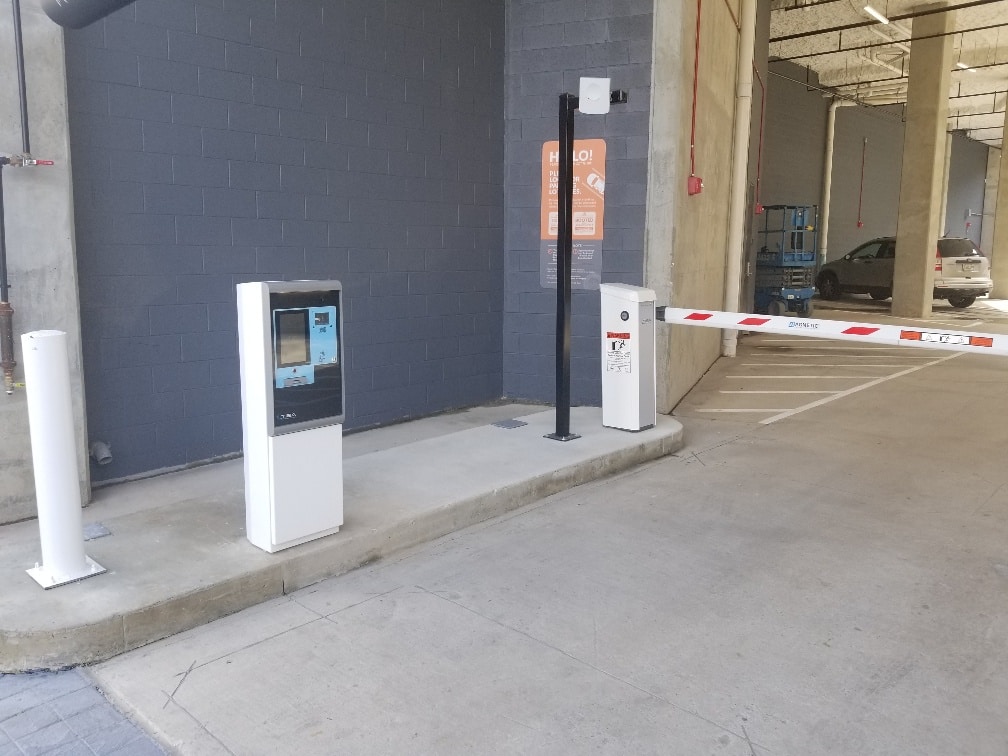 Speaker system connects to ticket system for controlled access parking, allowing for assistance communication.