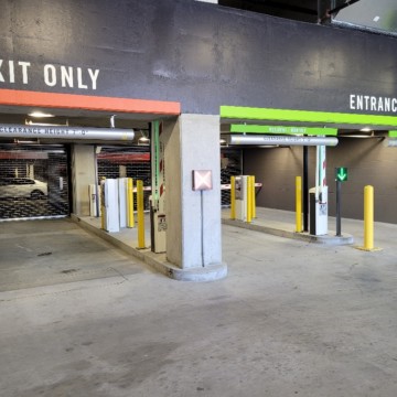 Traffic lanes with closed overhead doors deny access to secure parking area.