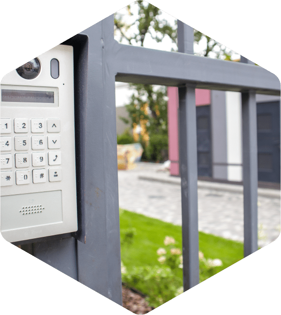 Keypad entry with intercom and camera system at the security gate entrance.