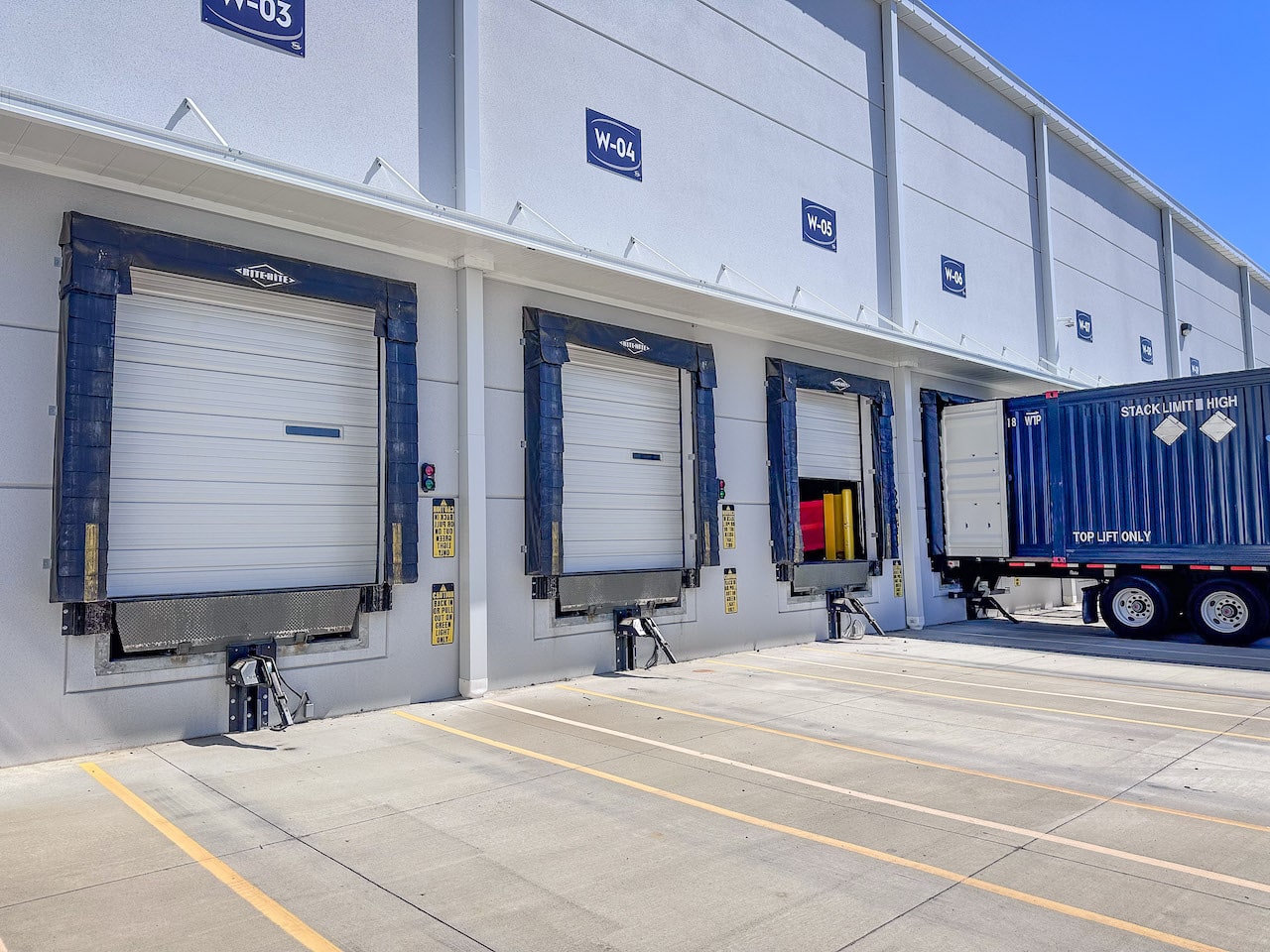 Commercial overhead doors with a truck attached to one of those