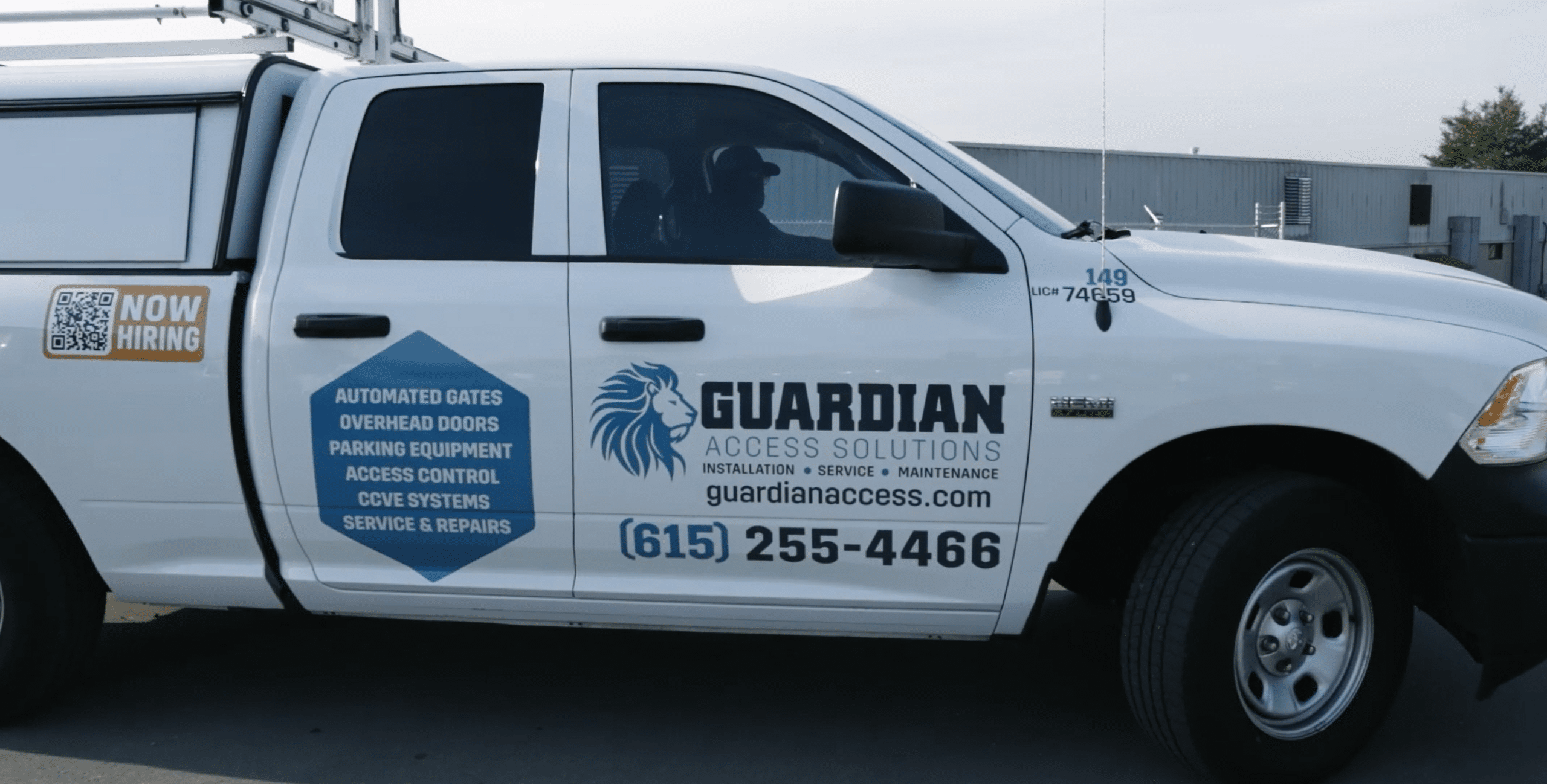 Guardian Access Solutions truck with brand logo and services on the passenger side.