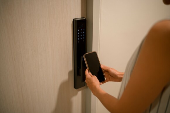 Person uses their mobile phone as their key to enter their hotel room.