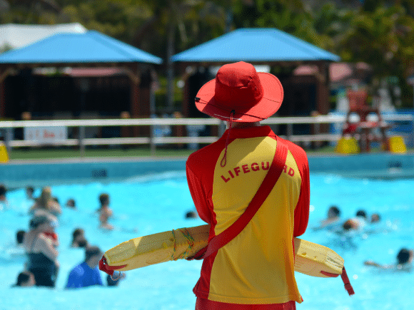 Lifeguard watching swimmers in a wave pool at a waterpark
