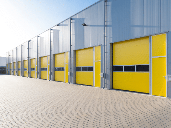 row of yellow ventilated commercial overhead doors